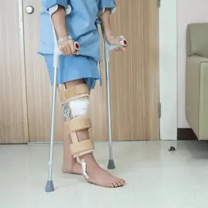 Patient uses crutches during physical therapy after knee surgery to regain safe mobility